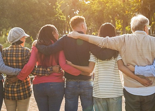 group of people with arms wrapped around each other 