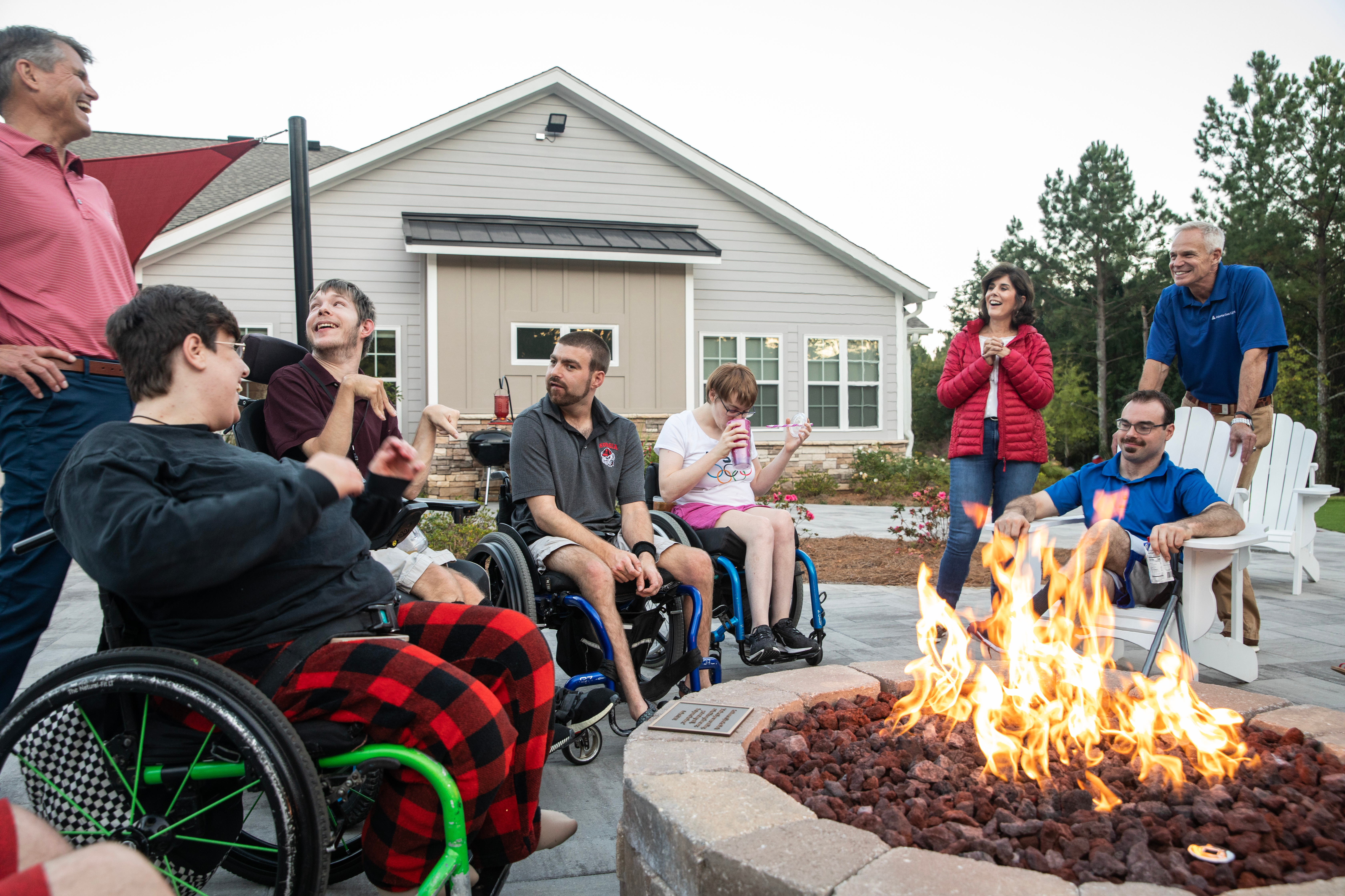 Group of volunteers with special needs people near a bondfire