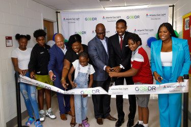 children and adults cutting ribbon