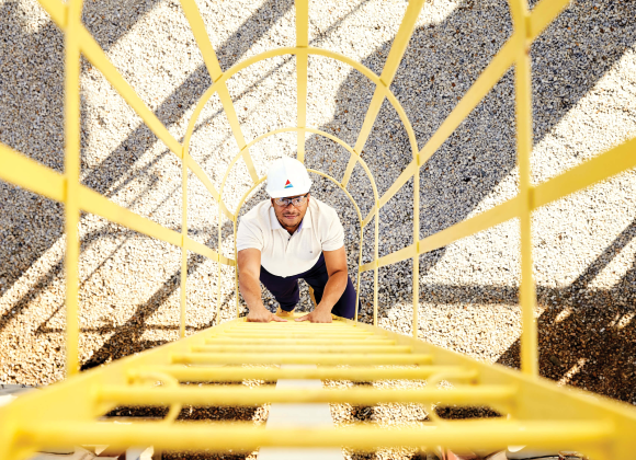 man climbing a latter on work site